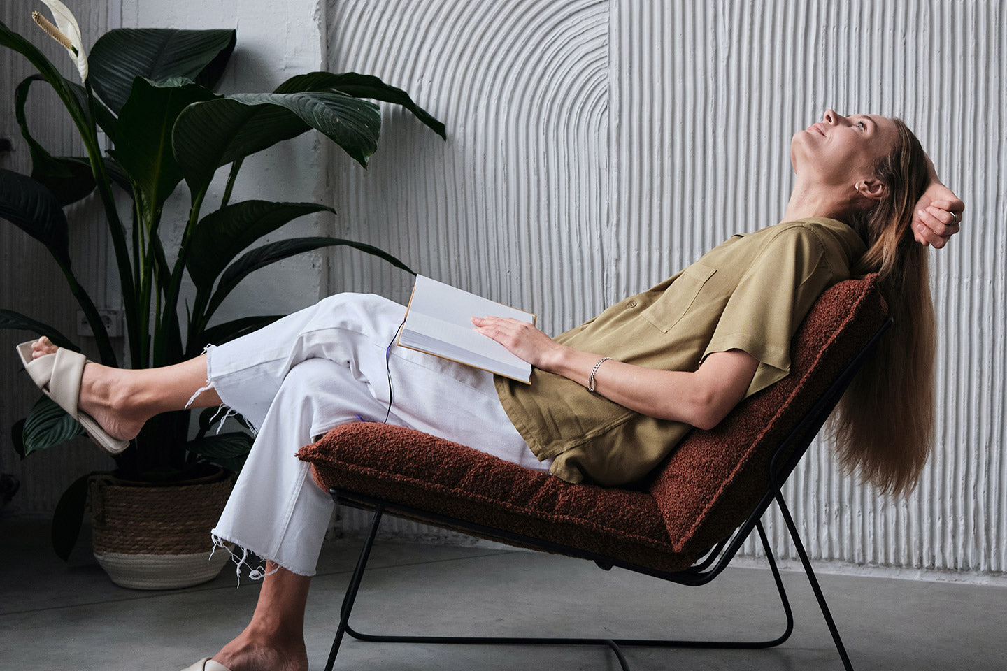 Woman leaning back in chair with noteback, personal coaching