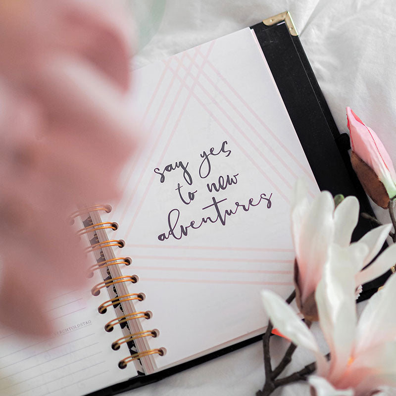 journal that says "say yes to new adventures" 
