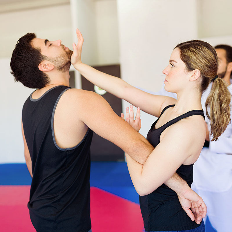 man and woman in self defense class, self partnership
