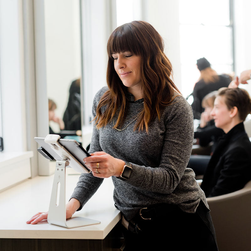 woman at a counter with iPad, starting a business resources